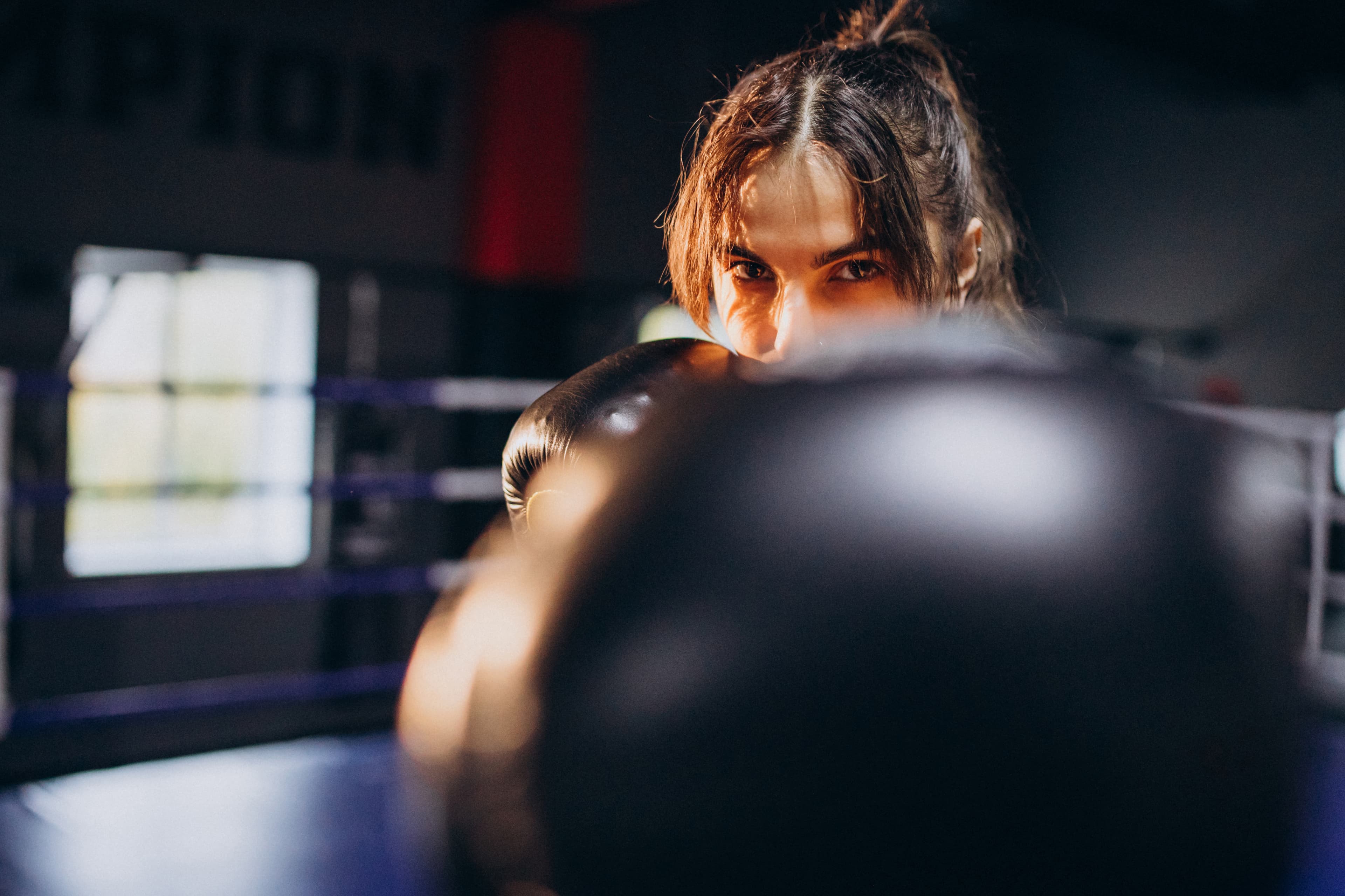 young woman boxer training gym